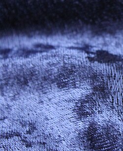 Weave details visible on a purple-colored velvet fabric