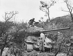 US soldiers of the 5th Cavalry Regiment examine a captured North Korean T-34 tank, Waegwan, eastern South Korea