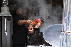 A lobster with its claws bound after being boiled alive