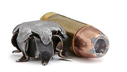 Right: .40 S&W round with hollow-point bullet Left: Expanded bullet of the same calibre with exposed lead core
