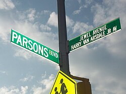 Cross-street signs for a single-named boulevard and a co-named avenue in Queens