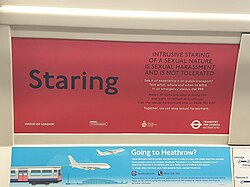 Text-based ad on a red background, saying "INTRUSIVE STARING OF A SEXUAL NATURE IS SEXUAL HARASSMENT AND IS NOT TOLERATED / See it or experience it on public transport? Text what, where and when to 6106. In an emergency always dial 999. Aware of someone who is doing this and want to remain anonymous? Call the sexual harassment line on 0800 783 0137. Together, we can stop sexual harassment." Sponsored by Mayor of London, CrimeStoppers, British Transport Police, and Transport for London.