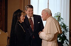 Pope John Paul II and then U.S. president Ronald Reagan (pictured with his wife Nancy) meeting in June 1982; both Pope John Paul II and Reagan were credited with contributing to the Revolutions of 1989, which led to the fall of communism and the end of the Cold War two years later, in 1991.