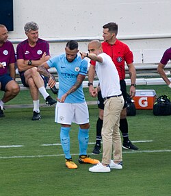 Guardiola giving instructions to Nicolás Otamendi during a friendly match against Tottenham Hotspur in the 2017 International Champions Cup
