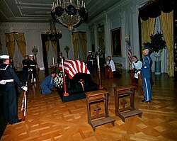 The body of John F. Kennedy in repose in the White House on November 23, 1963. William Walton helped research the funerary decorations for the room and the dressing for the catafalque.