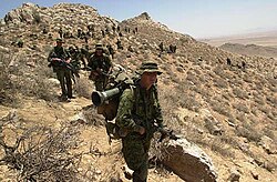 Canadian soldiers from 3PPCLI, search for al-Qaeda and Taliban fighters after an air assault, approach on an objective north of Qalati Ghilji, 2002