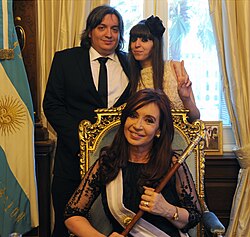 President Cristina Fernández de Kirchner in presidential regalia posing with her children, Máximo and Florencia in 2011
