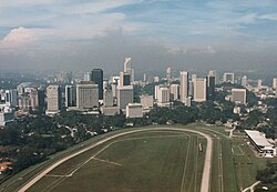 Kuala Lumpur cityscape in 1987 before KLCC was created. The race track in the foreground was replaced by the Petronas Towers and KLCC Park in 1998.[76]
