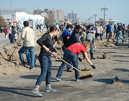 Civic engagement, including volunteering, is conducive to democratization. These volunteers are cleaning up after the 2012 Hurricane Sandy.