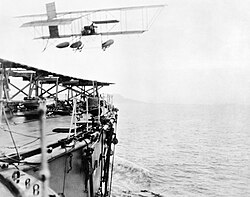 Commander C. Samson of the RNAS takes off from HMS Hibernia in his modified Shorts S.38 “hydro-aeroplane” to be the first pilot to take off from a ship underway at sea - 9 May 1912.