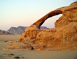A natural arch produced by the wind erosion of differentially weathered rock in Jebel Kharaz, Jordan