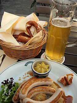Bavarian Bratwurst with mustard, a pretzel, and German beer