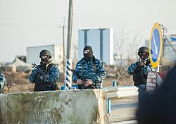 Armed men in Berkut uniform guarding a checkpoint at Chonhar, on the border of mainland Ukraine and Crimea, 10 March 2014