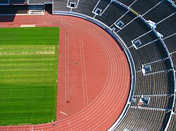 A typical athletics stadium with an oval running track and a grassy inner field