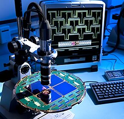 Now disproved evidence allegedly showing gravitational waves in the infant universe was found by the BICEP2 radio telescope. The microscopic examination of the focal plane of the BICEP2 detector is shown here.[30][31] In January 2015, however, the BICEP2 findings were confirmed to be the result of cosmic dust.[104]
