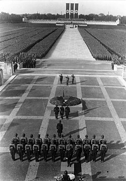 Heinrich Himmler, Hitler and Viktor Lutze perform the Nazi salute at the Nuremberg Rally, September 1934.