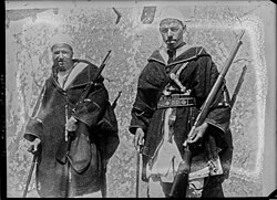 Berbers carrying captured rifles during Rif war, including a Mauser 1893 and a French Berthier carbine