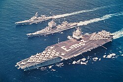 Task Force One, the world's first nuclear-powered task force. Enterprise, Long Beach and Bainbridge in formation in the Mediterranean, 18 June 1964. Enterprise crew members are spelling out Einstein's mass–energy equivalence formula E = mc2 on the flight deck.