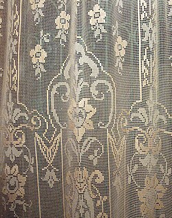 Detail of a "filé" lace curtain, a tradition of local handicrafts