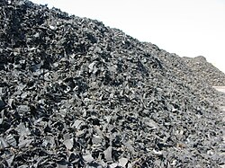 Mounds of shredded rubber tires ready for processing