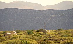 SD station and AERA antenna in the foreground, one FD building and the three HEAT telescopes in the background.