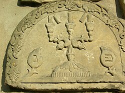 Tombstone of a Jewish woman depicting broken candles, a visual metaphor of the end of life