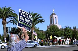 Protesters holding signs opposing Prop 8. A sign reads "Vote No on Prop 8" and "Equality for All"