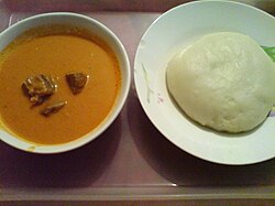Fufu (right) is a staple meal in West Africa and Central Africa. It is usually served with some peanut soup.