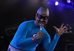 As part of the band's superhero image, each member of The Aquabats adopted a stage name and backstory. Christian Jacobs' alter ego is "The MC Bat Commander", whose trademark look includes a drawn-on mustache and blacked-out tooth.