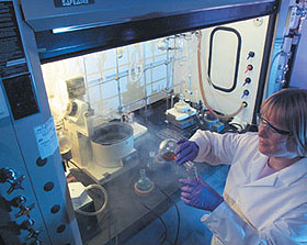 A chemist pours from a round-bottom flask at Lawrence Livermore National Laboratory, Livermore, California.