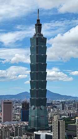 Photo of Taipei 101 tower against a blue sky.