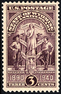 On July 10, 1940, the U.S. Post Office issued a postage stamp commemorating the 50th anniversary of Wyoming statehood. The engraving depicts the Wyoming state seal, which features a central figure of a woman in front of a banner reading 'equal rights'