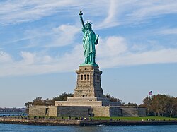 The Statue of Liberty in New York Harbor, a global symbol of the United States and its ideals[129]