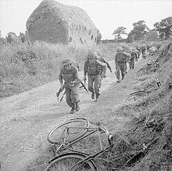 8th Battalion, Lincolnshire Regiment, abandon their bicycles and advance along a country lane during anti-invasion exercises at Weybourne in Norfolk, 23 July 1941