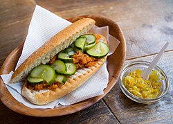 A Surinamese "broodje bakkeljauw" in the Netherlands (bun with shredded and spiced stockfish), with a chili paste made from Madame Jeanette peppers on the side