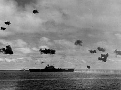 Japanese torpedo bombers fly past the USS Yorktown during the Battle of Midway, 4 June 1942