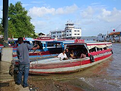 Small ferries take passengers across the Suriname River from Paramaribo to the Commewijne District