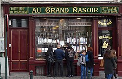 Au grand Rasoir, a Royal warrant holder with Royal crest.