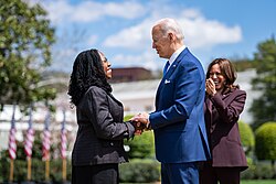 President Joe Biden with his Supreme Court appointee Justice Ketanji Brown Jackson and Vice President Kamala Harris (in background) following Brown Jackson's 2022 United States Senate confirmation