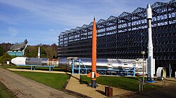 Europa II rocket (larger horizontal rocket in the background), Skylark sounding rocket (front centre-left), and a model of the Ariane 4 orbital rocket (to the right from Skylark) at Euro Space Center
