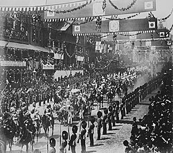 The Queen's landau processing along Regent Street, escorted by British Indian Army horsemen and the Household Cavalry.