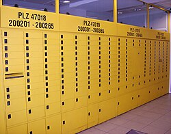 PO boxes of various sizes in a German post office, with their number range and postcodes written above them