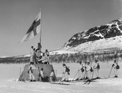 Finnish troops raise a flag on the three-country cairn in April 1945 at the close of the World War II in Finland.