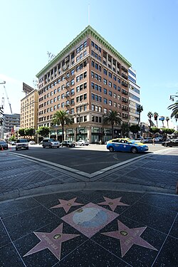 Hollywood Walk of Fame star at Hollywood and Vine (background Broadway Hollywood Building)