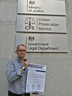 Trevor Moore holding an open letter to mark the tenth anniversary of Debbie Purdy's landmark legal case in 2019