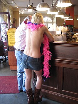 A topless woman at a French Quarter coffee house, Mardi Gras afternoon, 2009