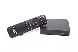 A digital media player in the form of a set-top box, pictured with its remote control
