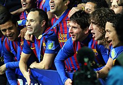 Messi (centre) and his teammates celebrate winning the 2011 FIFA Club World Cup