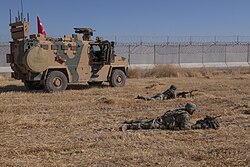 Turkish and American soldiers provide security for a joint ground patrol in the Northern Syria Buffer Zone, 24 September 2019