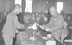General Chen Yi (right) accepting the receipt of General Order No. 1 from Rikichi Andō (left), the last Japanese governor-general of Taiwan, in Taipei City Hall